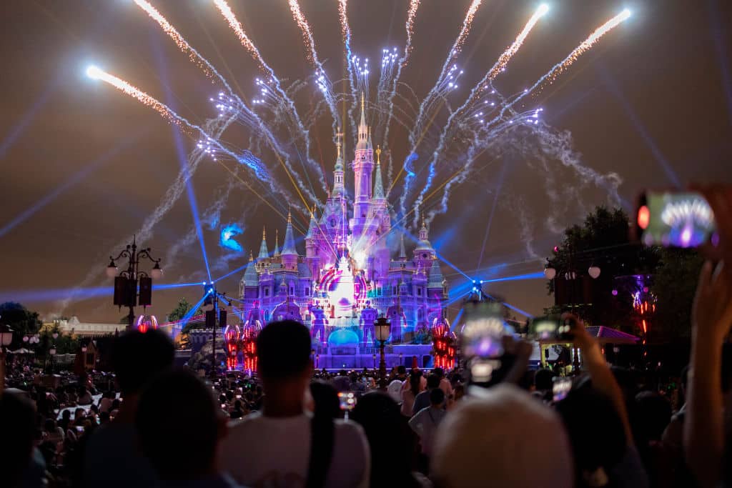 SHANGHAI, CHINA - JUNE 30: People attend the night show of the Enchanted Storybook Castle at Shanghai Disneyland on June 30, 2022 in Shanghai, China. (Photo by Hu Chengwei/Getty Images)