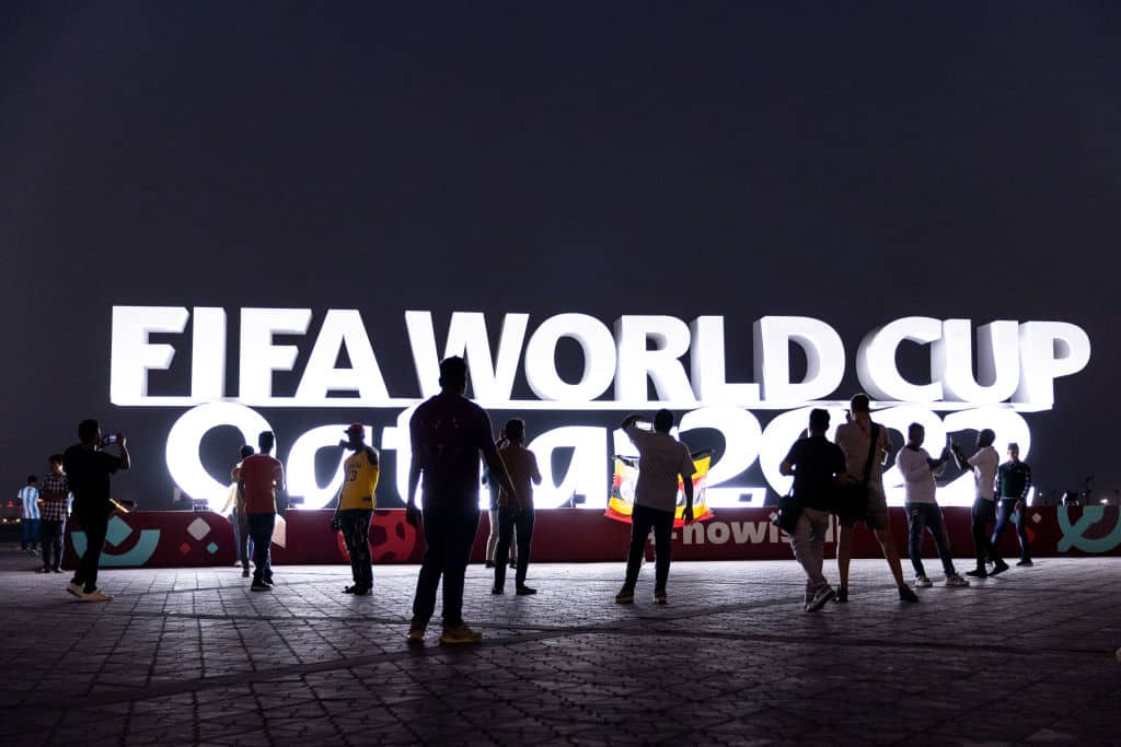 DOHA, QATAR - NOVEMBER 14: Members of the public pose for a pictures next to a Qatar 2022 World Cup logo at Doha Corniche ahead of the FIFA World Cup Qatar 2022 on November 14, 2022 in Doha, Qatar. (Photo by Maja Hitij - FIFA/FIFA via Getty Images)