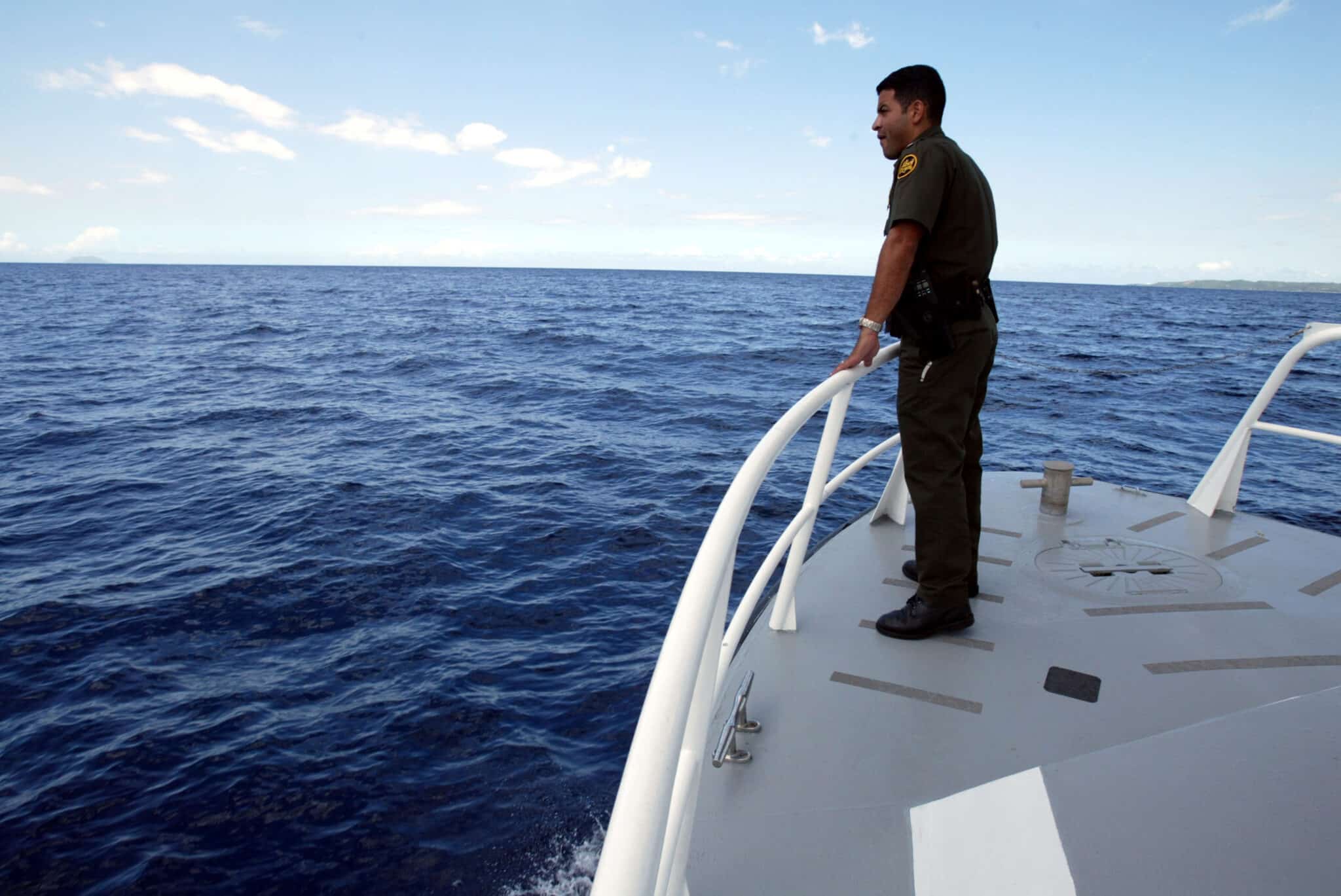 MAYAGUEZ, PUERTO RICO - APRIL 24:  Supervisory U.S. Border Patrol agent Xavier Morales scans the horizon as he rides in the patrol boat April 24, 2004 near Mayaguez, Puerto Rico. A record number of migrants from the Dominican Republic are trying to illegally enter the United States through Puerto Rico. The total number of unlawful migrants attempting to enter Puerto Rico during the 2004 fiscal year is 5,756 as apposed to a total of 3, 477 for all of the 2003 fiscal year. Due to a sagging economy, rising cost of living and high unemployment people are fleeing the Dominican Republic in search of a better life.  (Photo by Joe Raedle/Getty Images)