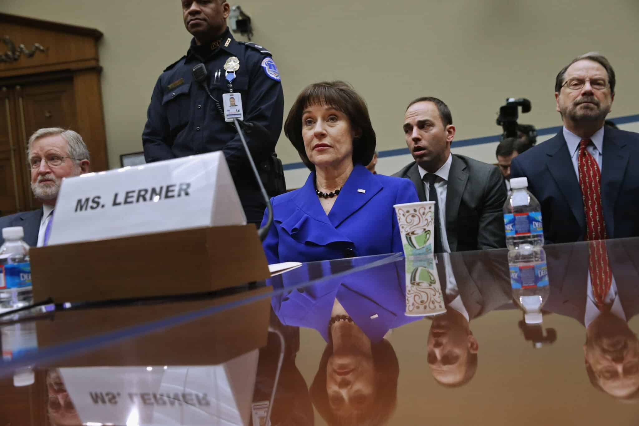 WASHINGTON, DC - MARCH 05:  Former Internal Revenue Service official Lois Lerner (C) exercises her Fifth Amendment right not to speak about the IRS targeting investigation before the House Oversight and Government Reform Committee during a hearing in the Rayburn House Office Building March 5, 2014 in Washington, DC. Chairman Darrell Issa (R-CA) adjuourned after Lerner refused to answer questions about the investigation.  (Photo by Chip Somodevilla/Getty Images)