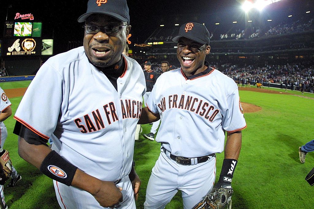 ATLANTA, UNITED STATES:  San Francisco Giants manager Dusty Baker (L) and player Reggie Sanders celebrate after the Giants clinch the National League Division Series against the Atlanta Braves at Turner Field, 07 October 2002 in Atlanta, Georgia. The Giants beat the Braves 3-1.   AFP PHOTO/Steve SCHAEFER (Photo credit should read STEVE SCHAEFER/AFP via Getty Images)