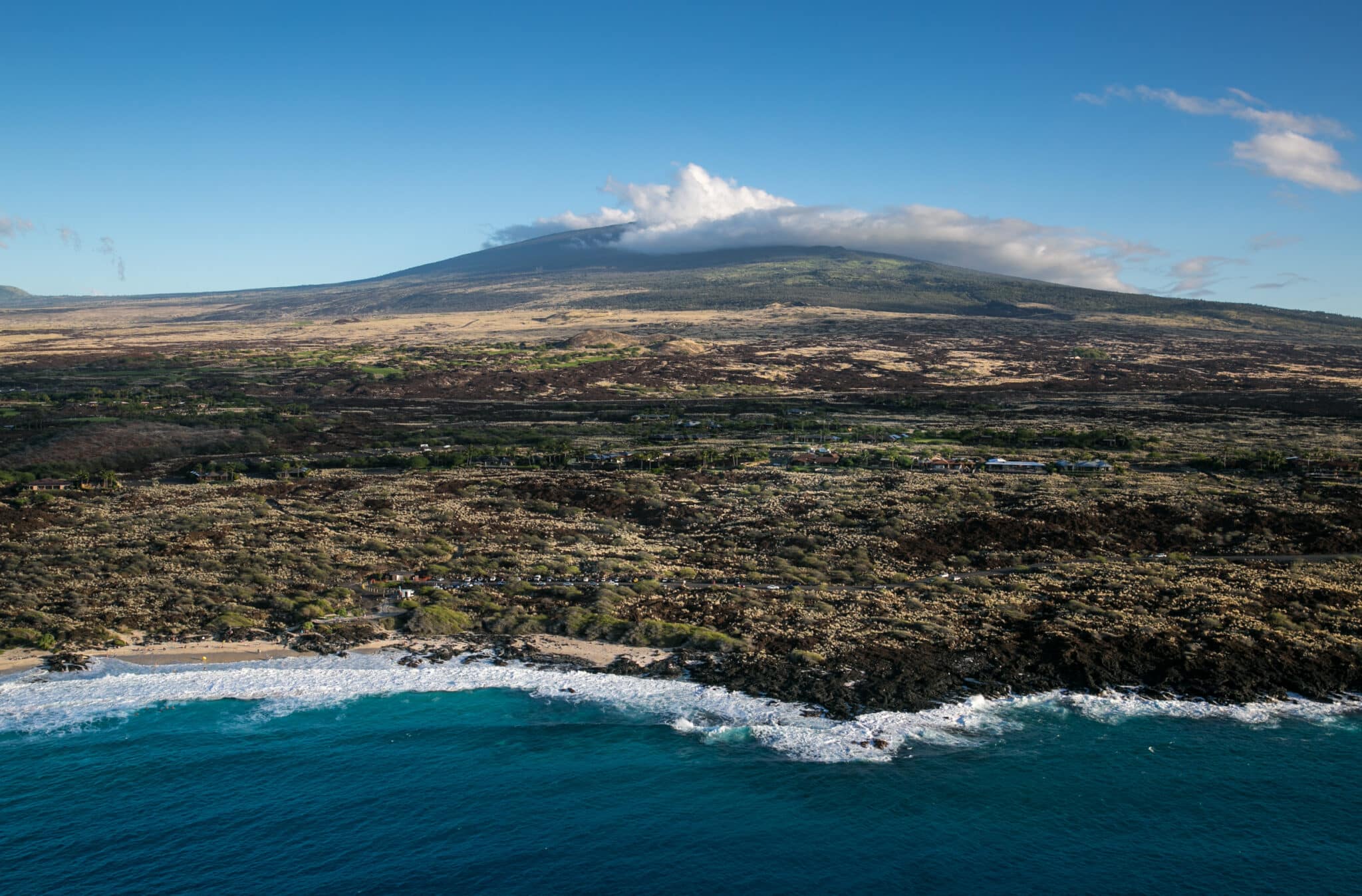 KONA COAST, HI - DECEMBER 16:  A nearly deserted beach at the edge on an old Mauna Loa lava flow is viewed on December 16, 2016, in this aerial photo taken along the Kona Kohala Coast, Hawaii. Hawaii, the largest of all the Hawaiian Islands at 4,000 square miles, features active volcanoes, large cattle ranches, unusual flora and fauna, waterfalls, rainforests, and occasionally, snowcapped mountains. (Photo by George Rose/Getty Images)