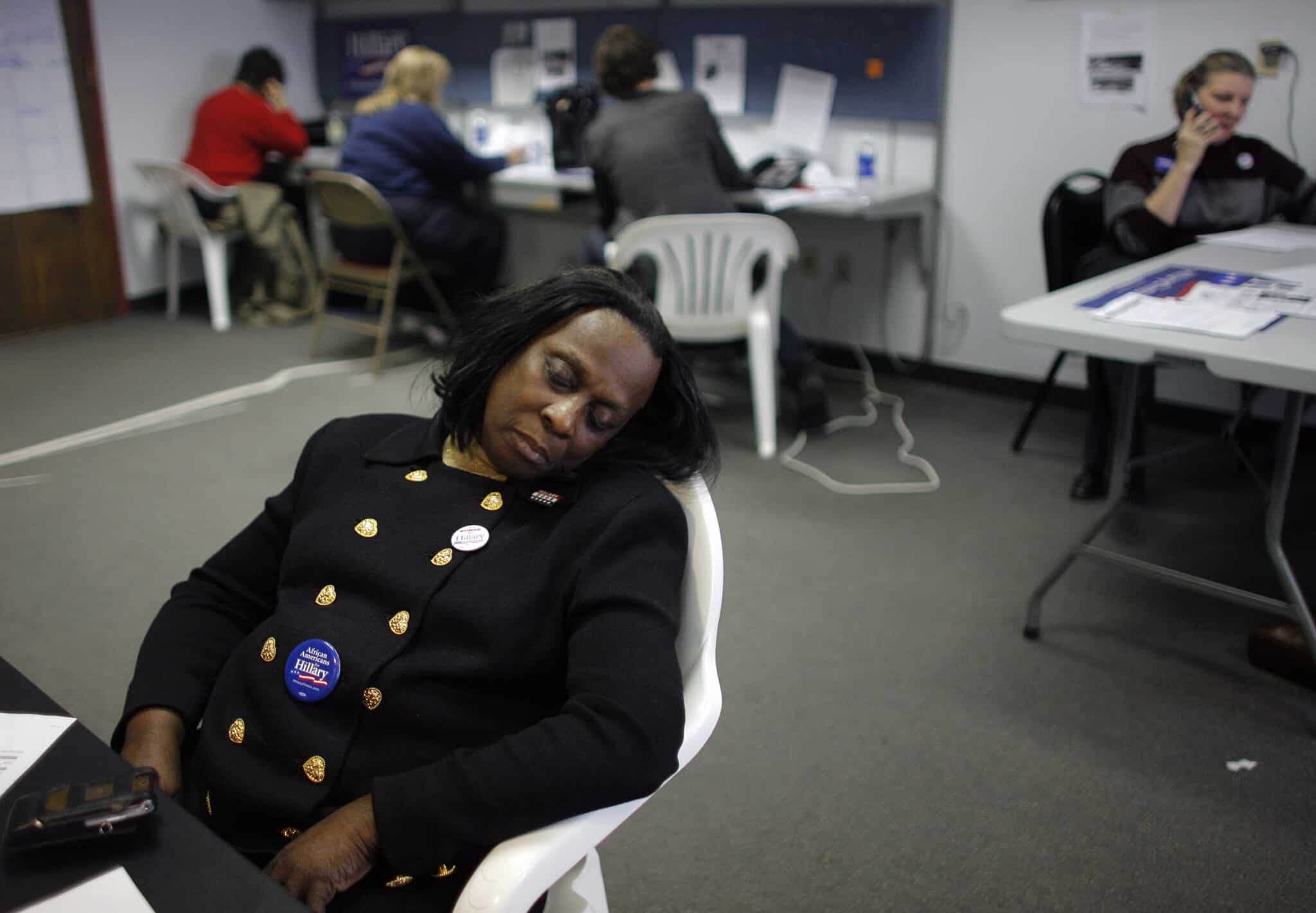 COLUMBUS, OH - MARCH 2:  A woman sleeps as volunteers make phone calls at the campaign headquarters of Sen. Hillary Clinton (D-NY) March 2, 2008 in Columbus, Ohio. A tight Democratic race between presidential hopefuls Sen. Hillary Clinton (D-NY) and Sen. Barack Obama (D-IL) have volunteers working to communicate and pass on their candidates' message to voters in Ohio.   (Photo by Eric Thayer/Getty Images)