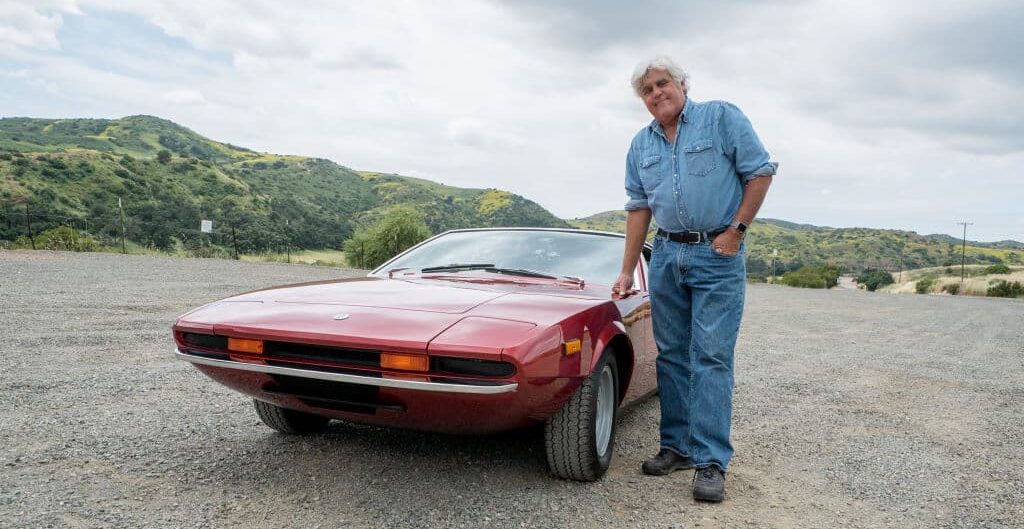 JAY LENO'S GARAGE -- Peter Giacobbi with featured cars Tjaarda, DeLorean and Testarossa -- Pictured: Jay Leno -- (Photo by: Walker Dalton/CNBC/NBCU Photo Bank/NBCUniversal via Getty Images)