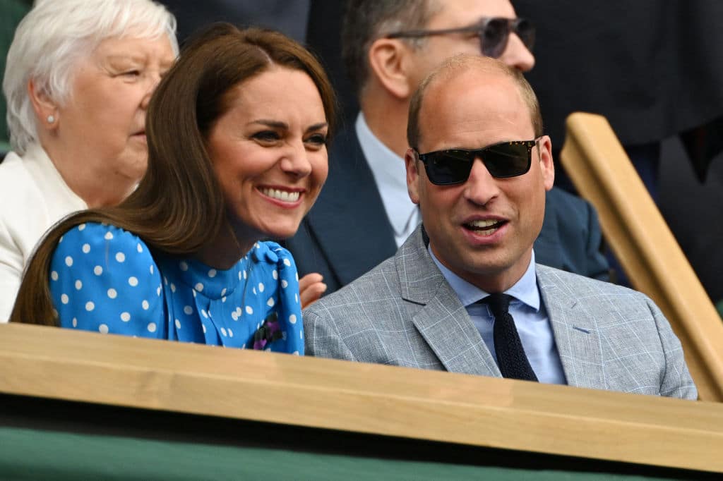 Britain's Catherine, Duchess of Cambridge (L) and Britain's Prince William, Duke of Cambridge, smile in the Royal Box at the Centre court during the men's singles quarter final tennis match between Serbia's Novak Djokovic and Italy's Jannik Sinner on the ninth day of the 2022 Wimbledon Championships at The All England Tennis Club in Wimbledon, southwest London, on July 5, 2022. - RESTRICTED TO EDITORIAL USE (Photo by SEBASTIEN BOZON / AFP) / RESTRICTED TO EDITORIAL USE (Photo by SEBASTIEN BOZON/AFP via Getty Images)