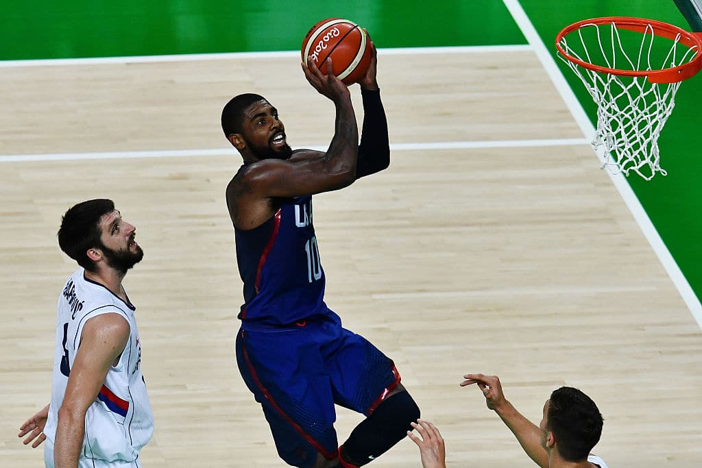 USA's guard Kyrie Irving (C) scores past Serbia's point guard Stefan Markovic during a Men's Gold medal basketball match between Serbia and USA at the Carioca Arena 1 in Rio de Janeiro on August 21, 2016 during the Rio 2016 Olympic Games. / AFP / Jewel SAMAD        (Photo credit should read JEWEL SAMAD/AFP via Getty Images)