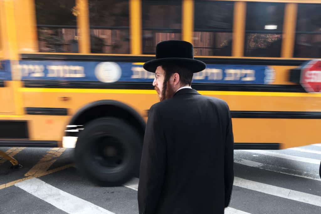NEW YORK, NEW YORK - SEPTEMBER 12: A yeshiva school bus drives through Borough Park on September 12, 2022 in the Brooklyn borough of New York City. Following recent reports and test results showing yeshiva students not receiving an adequate education, New York’s Board of Regents will vote this week on a proposal that would allow the state to reject a yeshiva’s secular curriculum. The Hasidic Jewish community has pushed back on reforms in yeshiva schools, which number over 300 in New York City. Critics of the schools have long said that graduating students are not receiving an education that prepares them for a modern job market. (Photo by Spencer Platt/Getty Images)