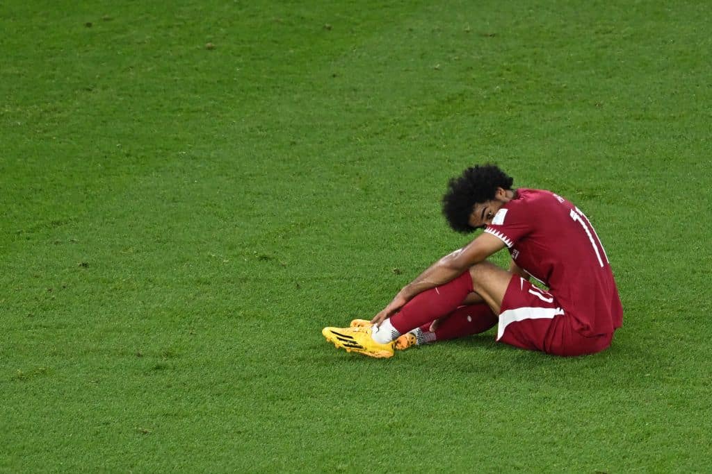 Qatar's forward #11 Akram Afif reacts after the final whistle of the Qatar 2022 World Cup Group A football match between Qatar and Senegal at the Al-Thumama Stadium in Doha on November 25, 2022. (Photo by MANAN VATSYAYANA / AFP) (Photo by MANAN VATSYAYANA/AFP via Getty Images)