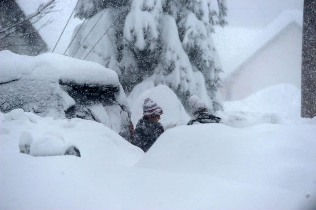 HAMBURG, NY - NOVEMBER 18: Braden Ahmed digs out after an intense lake-effect snowstorm impacted the area on November 18, 2022 in Hamburg, New York. Around Buffalo and the surrounding suburbs, the snowstorm resulted in up to five feet of accumulation and additional snowfall is forecast for the weekend. The band of snow is expected to return to the same hard hit areas and has resulted in at least two deaths.  (Photo by John Normile/Getty Images)