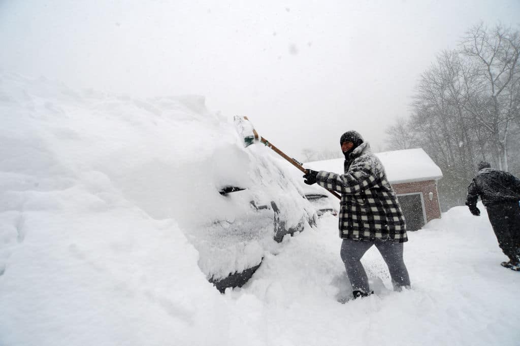 HAMBURG, NY - November 18: Michelle Kucalski digs out her car after an intense lake-effect snowstorm impacted the area on November 18, 2022 in Hamburg, New York. Around Buffalo and the surrounding suburbs, the snowstorm resulted in up to four feet of accumulation, and additional snowfall is forecast for the weekend. (Photo by John Normile/Getty Images)