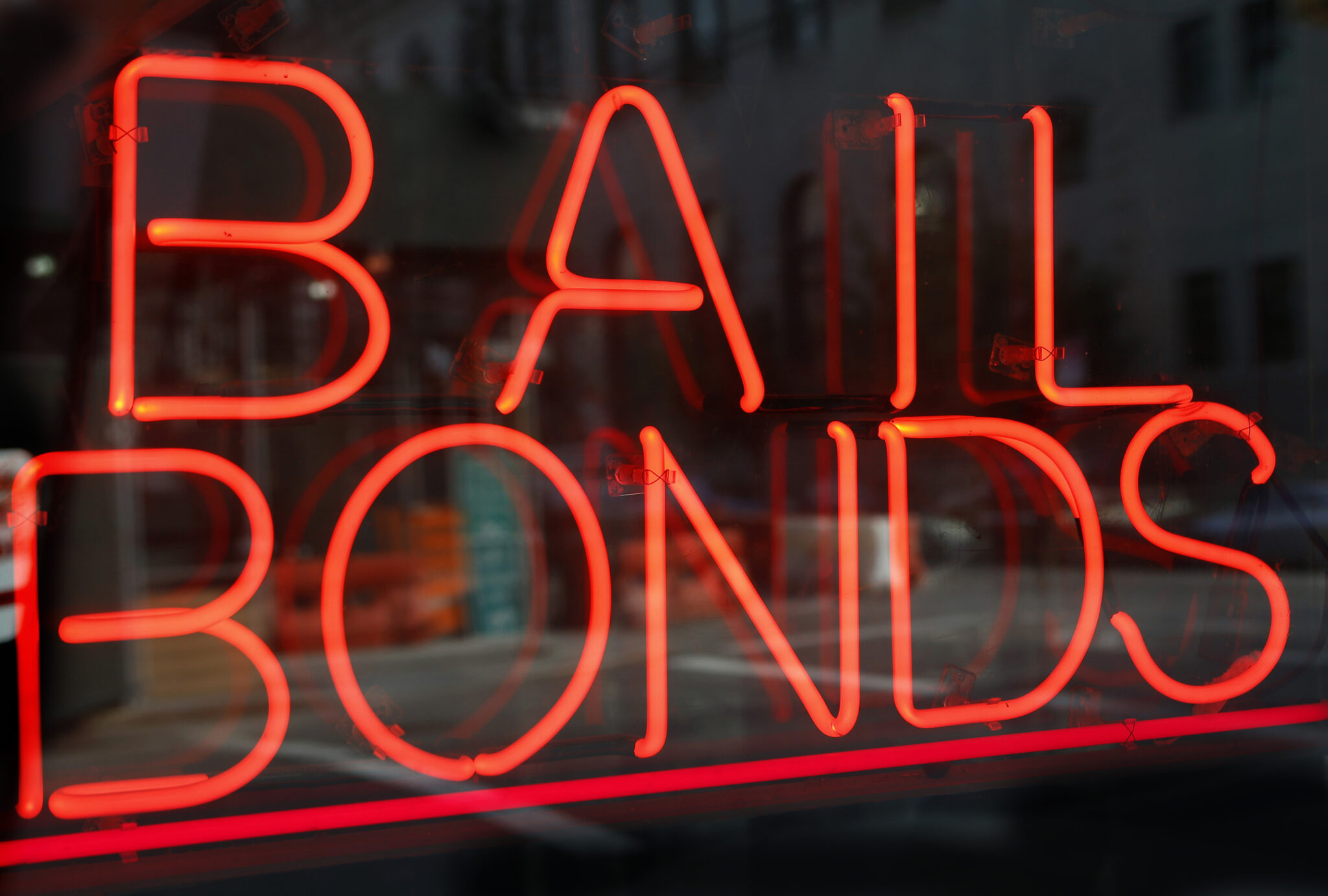 FILE - In this Tuesday, July 7, 2015, file photo, a sign advertising a bail bonds business is displayed near Brooklyn's jail and courthouse complex in New York. A national effort is launching that aims to help low-income defendants get out of jail by bailing them out as their criminal cases progress through the courts. (AP Photo/Kathy Willens, File)