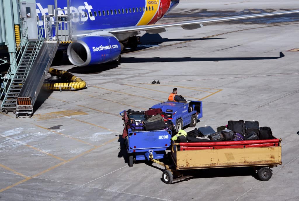 ALBUQUERQUE, NEW MEXICO - FEBRUARY 25, 2019: A Southwest Airlines baggage handler delivers passenger luggage to the terminal at Albuquerque International Sunport in Albuquerque, New Mexico. (Photo by Robert Alexander/Getty Images)