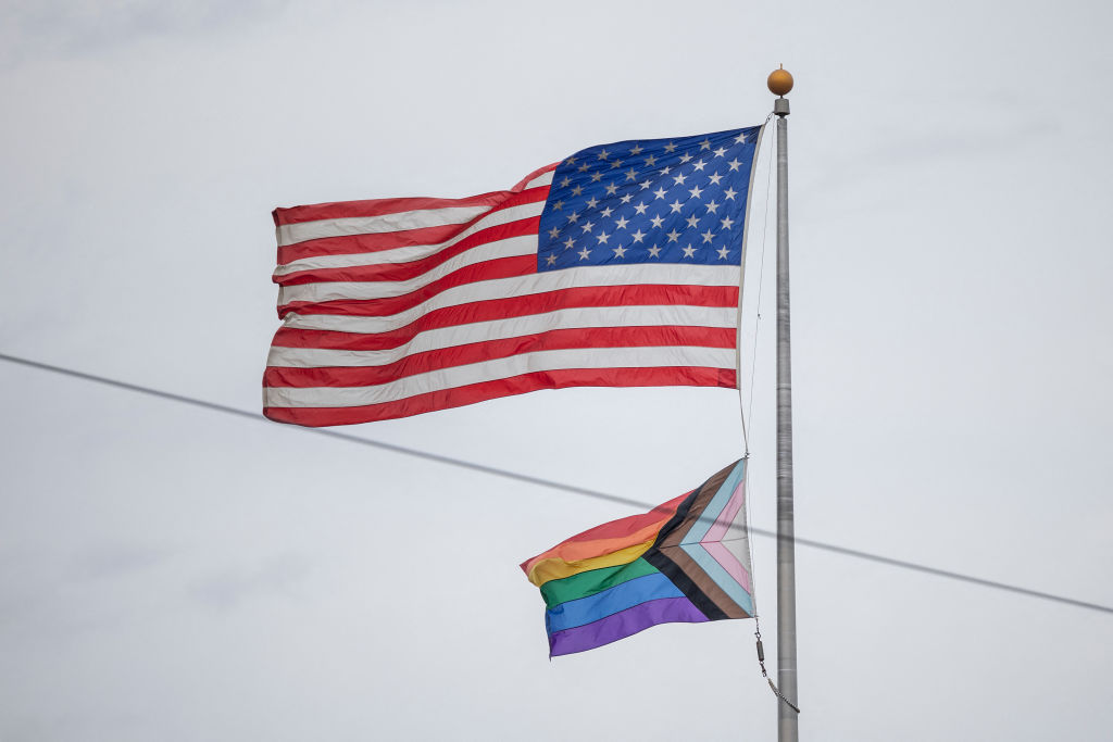 A United States of America flag and a rainbow flag are seen waving from the US consulate in the Sandton area of Johannesburg, on October 27, 2022. - The US government issued an alert of a possible terrorist attack during the weekend in the Sandton area of South Africa's largest city Johannesburg. Johannesburg's annual gay pride parade is scheduled to take place in the Sandton area on the same Saturday, the first in-person event after a two-year hiatus caused by the Covid-19 pandemic restrictions. (Photo by Michele Spatari / AFP) (Photo by MICHELE SPATARI/AFP via Getty Images)