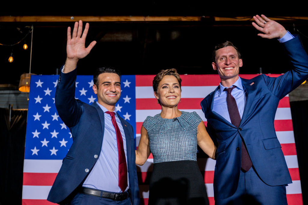 PHOENIX, ARIZONA - AUGUST 01: (L-R) Republican candidate for state attorney general Abraham Hamadeh, Republican gubernatorial candidate Kari Lake, and Republican U.S. senatorial candidate Blake Masters wave to supporters at the conclusion of a campaign event on the eve of the primary at the Duce bar on August 01, 2022 in Phoenix, Arizona. Lake, who has the endorsement of former President Donald Trump, is facing Karrin Taylor Robson, who is being backed by former Vice President Mike Pence. (Photo by Brandon Bell/Getty Images)