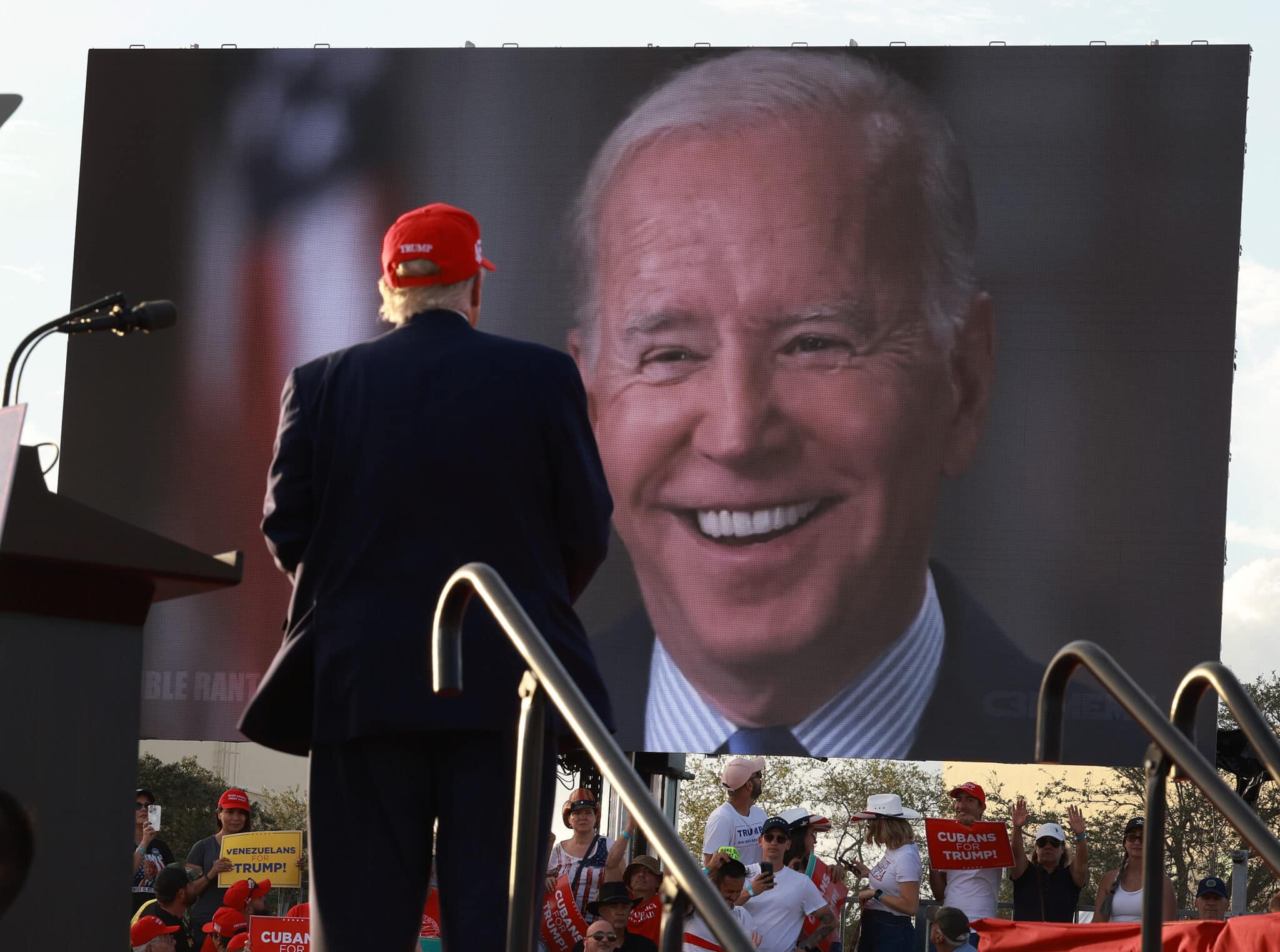 MIAMI, FLORIDA - NOVEMBER 06: Former U.S. President Donald Trump watches a video of President Joe Biden playing during a rally for Sen. Marco Rubio (R-FL) at the Miami-Dade Country Fair and Exposition on November 6, 2022 in Miami, Florida. Rubio faces U.S. Rep. Val Demings (D-FL) in his reelection bid in Tuesday's general election.  (Photo by Joe Raedle/Getty Images)