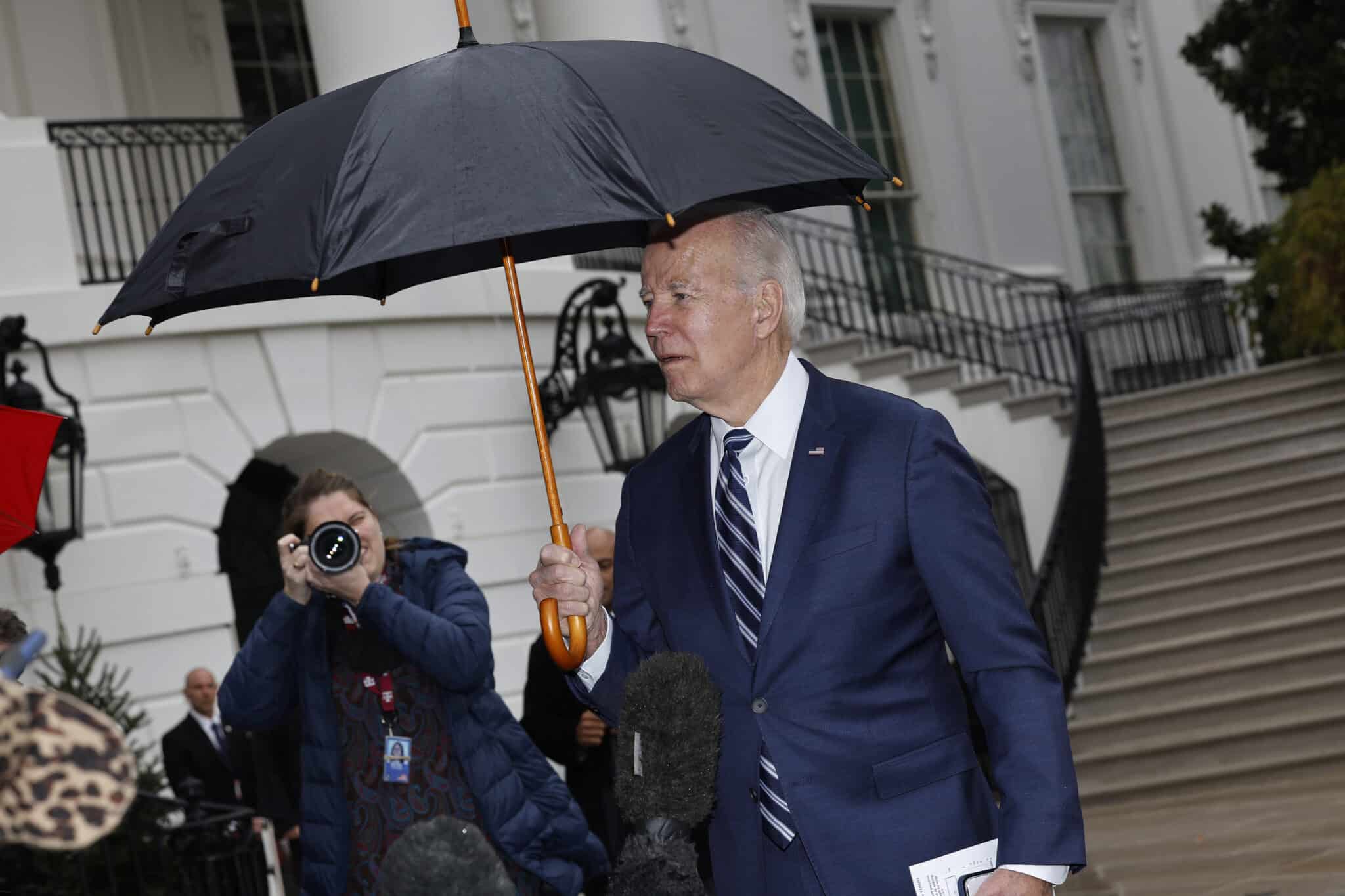 WASHINGTON, DC - DECEMBER 06: U.S. President Joe Biden briefly speaks with reporters in the rain as he departs the White House on December 06, 2022 in Washington, DC. Biden is traveling to Phoenix, Arizona, to tour the Taiwan Semiconductor Manufacturing Company chip-making factory and give a speech about his economic plan. (Photo by Chip Somodevilla/Getty Images)