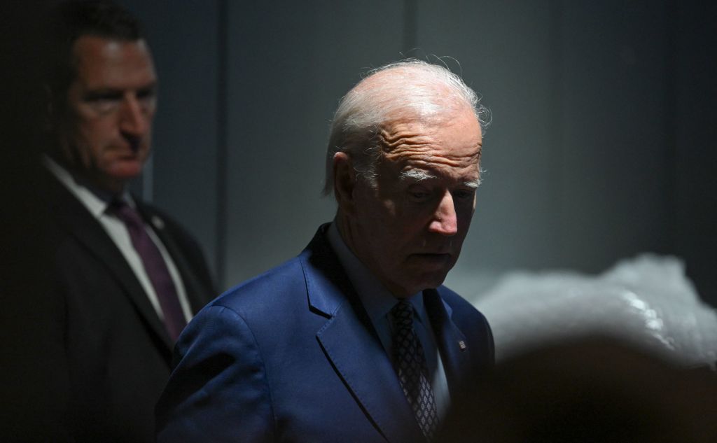 A secret service agent stands behind US President Joe Biden as he waits backstage of a rally hosted by the Democratic Party of New Mexico at Ted M. Gallegos Community Center in Albuquerque, New Mexico, on November 3, 2022. (Photo by SAUL LOEB / AFP) (Photo by SAUL LOEB/AFP via Getty Images)