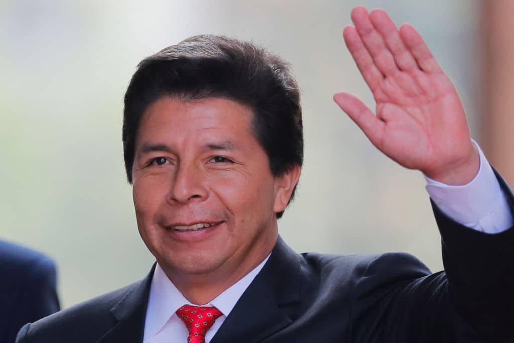 Peruvian President Pedro Castillo waves on his arrival to La Moneda presidential palace in Santiago, on November 29, 2022, during his visit to Chile. (Photo by JAVIER TORRES / AFP) (Photo by JAVIER TORRES/AFP via Getty Images)