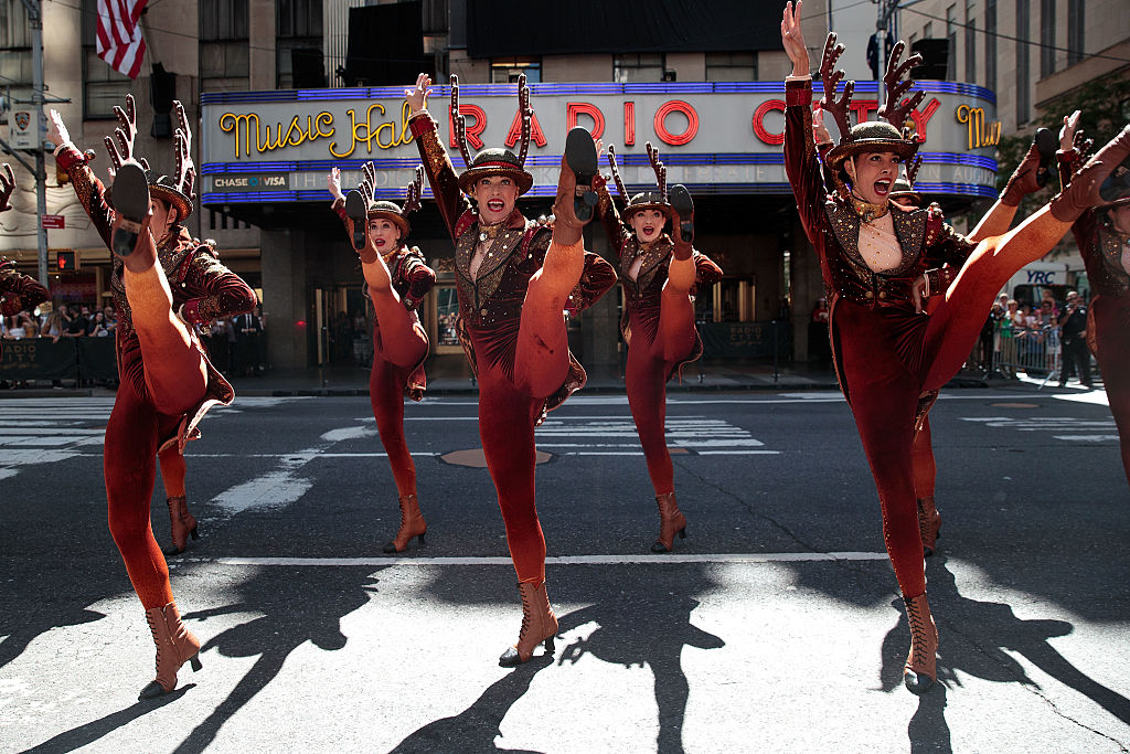 NEW YORK, NY - AUGUST 23: Members of the 'Radio City Rockettes' perform during their annual 'Christmas in August' event outside of Radio City Music Hall on 6th Avenue, August 23, 2016 in New York City. The Rockettes performed 'Sleigh Ride' in the street while traffic was stopped on 6th Avenue. (Photo by Drew Angerer/Getty Images)