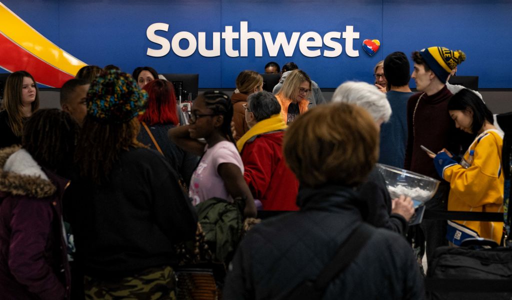 Travellers wait in line at the Southwest Airlines ticketing counter at Nashville International Airport after the airline cancelled thousands of flights in Nashville, Tennessee, on December 27, 2022. - More than 10,000 flights cancelled over the Christmas holiday, chaos at airports across America: Southwest Airlines found itself in the hot seat on December 27, 2022, as the airline behind the lion's share of the weather-linked travel mayhem. (Photo by Seth Herald / AFP) (Photo by SETH HERALD/AFP via Getty Images)