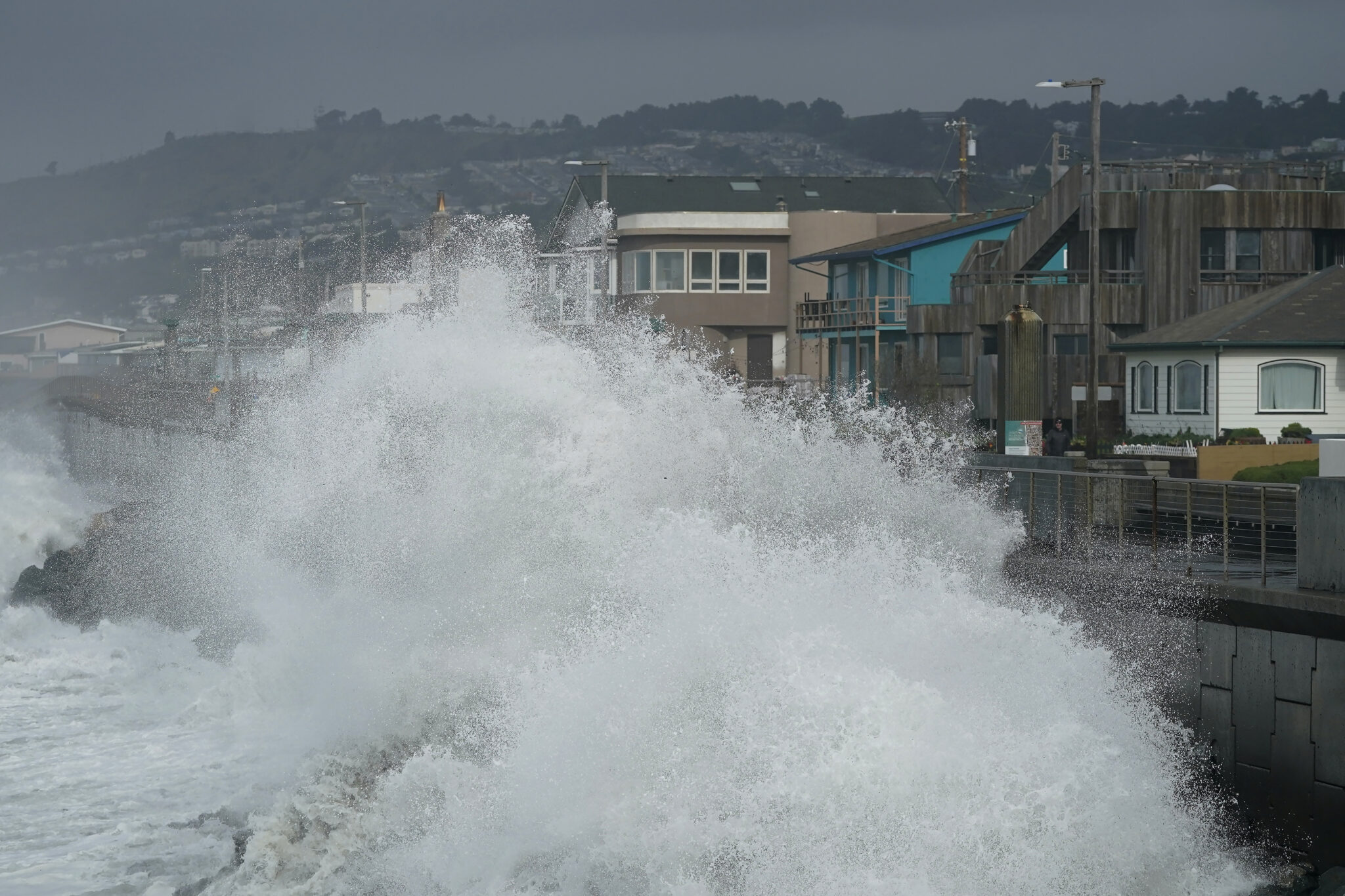 Waves crash into a seawall in Pacifica, Calif., Friday, Jan. 6, 2023. California weather calmed Friday but the lull was expected to be brief as more Pacific storms lined up to blast into the state, where successive powerful weather systems have knocked out power to thousands, battered the coastline, flooded streets, toppled trees and caused at least six deaths. (AP Photo/Jeff Chiu)