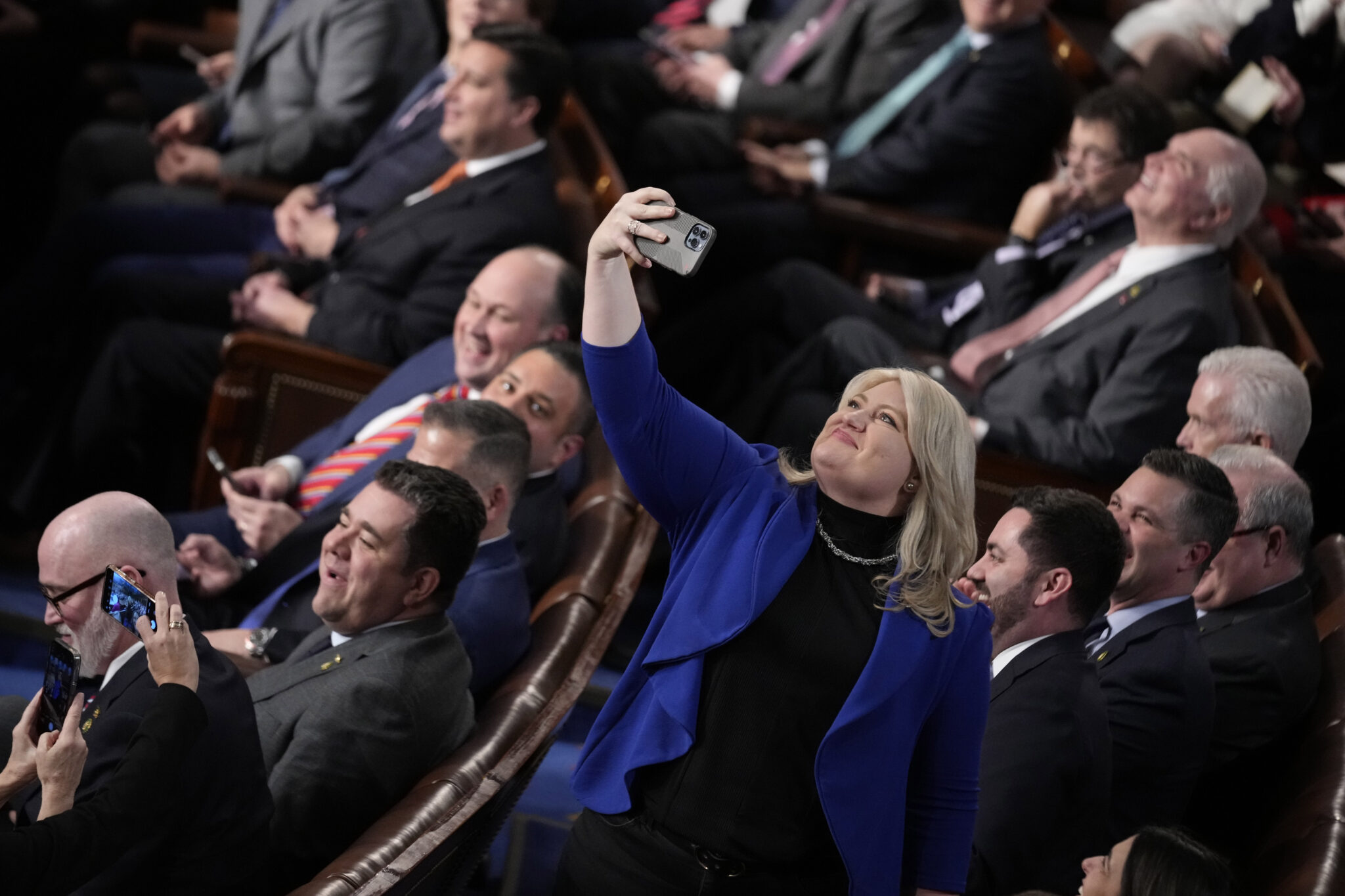 Rep. Kat Cammack, R-Fla., takes a selfie after Rep. Kevin McCarthy, R-Calif., was elected speaker in the 15th round of voting as the House entered the fifth day trying to elect a speaker and convene the 118th Congress in Washington, early Saturday, Jan. 7, 2023. (AP Photo/Andrew Harnik)