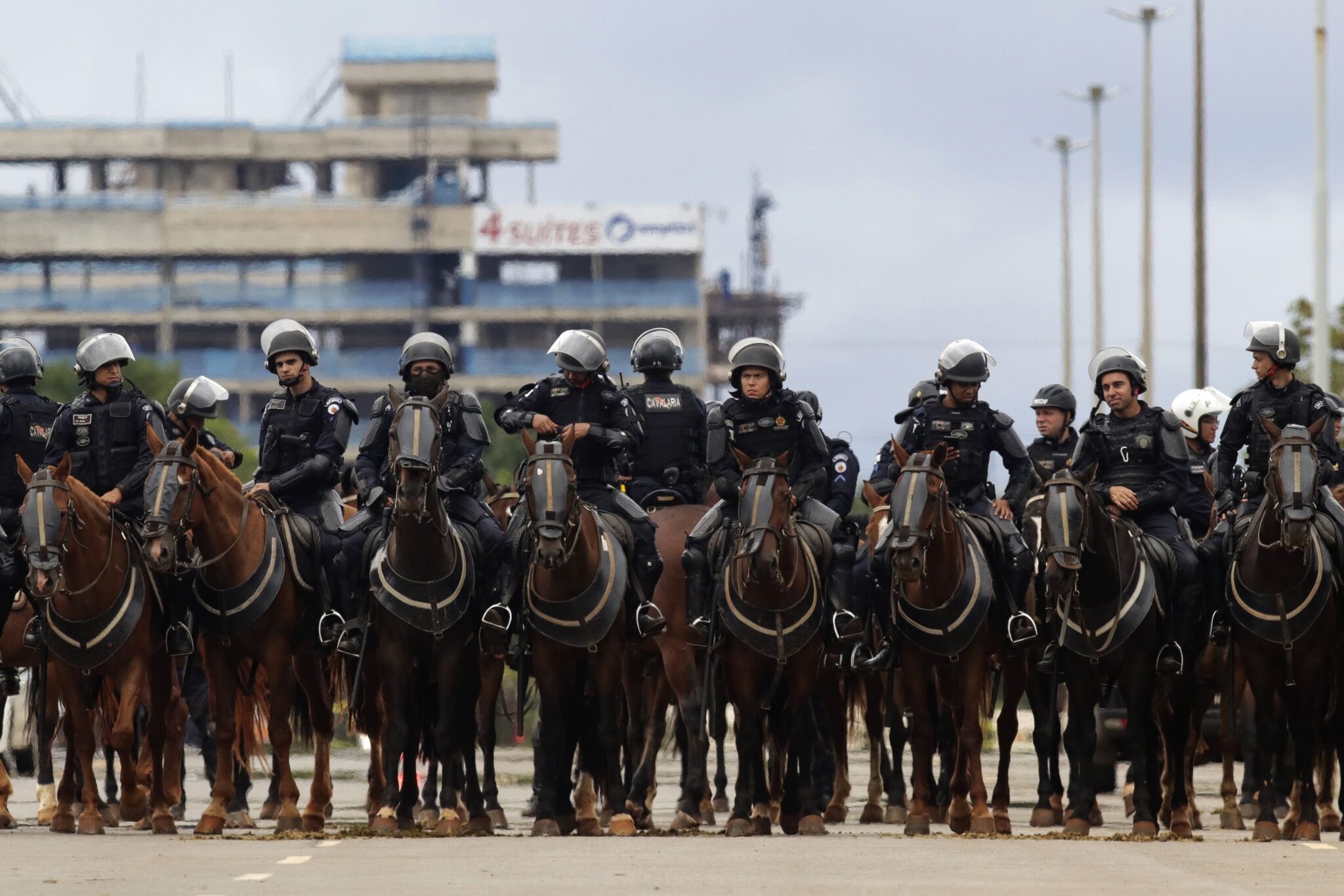 Mounted police watch as supporters of former Brazilian President Jair Bolsonaro depart their encampment outside army headquarters in Brasilia, Brazil, Monday, Jan. 9, 2023, the day after Bolsonaro supporters stormed government buildings in the capital. (AP Photo/Gustavo Moreno)