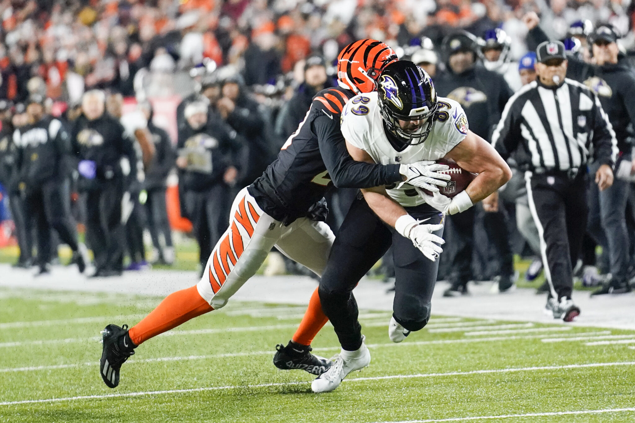 Baltimore Ravens tight end Mark Andrews (89) fights for yards as Cincinnati Bengals cornerback Eli Apple tackles during the first half of an NFL wild-card playoff football game, Sunday, Jan. 15, 2023, in Cincinnati. (AP Photo/Joshua A. Bickel)