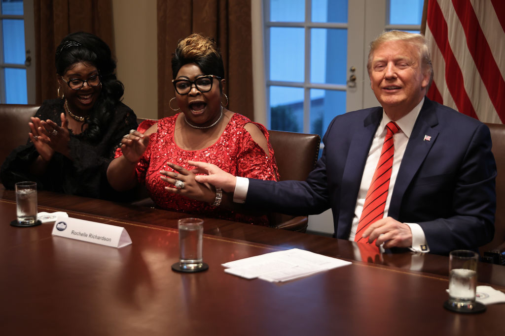 WASHINGTON, DC - FEBRUARY 27: U.S. President Donald Trump (R) listens as Lynette 'Diamond' Hardaway (L) and Rochelle 'Silk' Richardson praise him during a news conference and meeting with African American supporters in the Cabinet Room at the White House February 27, 2020 in Washington, DC. The president talked about the economic advances African Americans have made under his administration, about the government's response to the global coronavirus threat and how dishonest he thinks the news media can be to him. He did not answer reporters' questions about the S&P 500 taking its worst loss in almost nine years. (Photo by Chip Somodevilla/Getty Images)