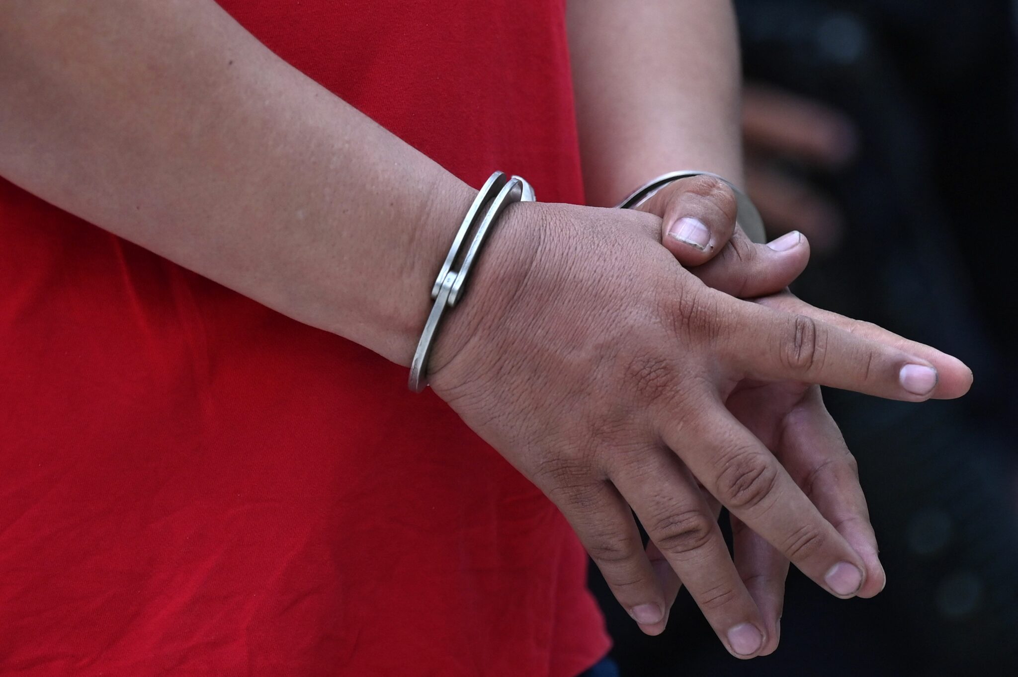 A man is seen handcuffed after being arrested by the national civil police on corruption charges in San Salvador on April 26, 2021. - The Salvadoran National Civil Police (PNC), Attorney General's Office (FGR) and Ministry of Justice and Security carried out an operation called Monarca (Monarch), in which 16 people were captured, including two mayors and a former deputy accused of corruption. (Photo by MARVIN RECINOS / AFP) (Photo by MARVIN RECINOS/AFP via Getty Images)