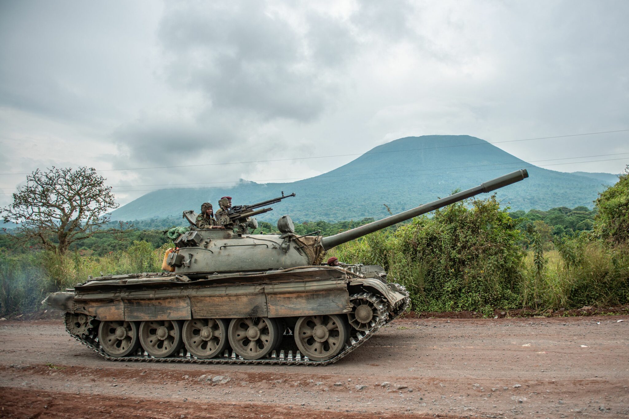 TOPSHOT - A Congolese army tank heads towards the front line near Kibumba in the area surrounding the North Kivu city of Goma on May 25, 2022 during clashes between the Congolese army and M23 rebels. - DR Congo soldiers fought M23 militiamen on several fronts in the troubled east of the country Wednesday, military and local officials said, with the government appearing to implicate Rwanda in the violent flare-up. (Photo by Arlette Bashizi / AFP) (Photo by ARLETTE BASHIZI/AFP via Getty Images)
