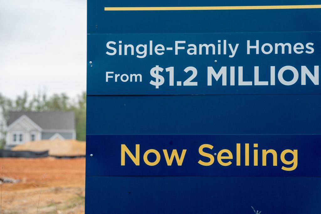 A sign is displayed in front of a new housing development in Burke, Virginia, on April 26, 2022. - Sales of new homes fell in the US last month, government data said on April 26, as high prices continued to crimp demand. Sales dropped to an annualized rate of 763,000, seasonally adjusted, less than analysts anticipated and 8.6 percent below the rate in February, which was revised sharply upwards, the Commerce Department reported. (Photo by Stefani Reynolds / AFP) (Photo by STEFANI REYNOLDS/AFP via Getty Images)