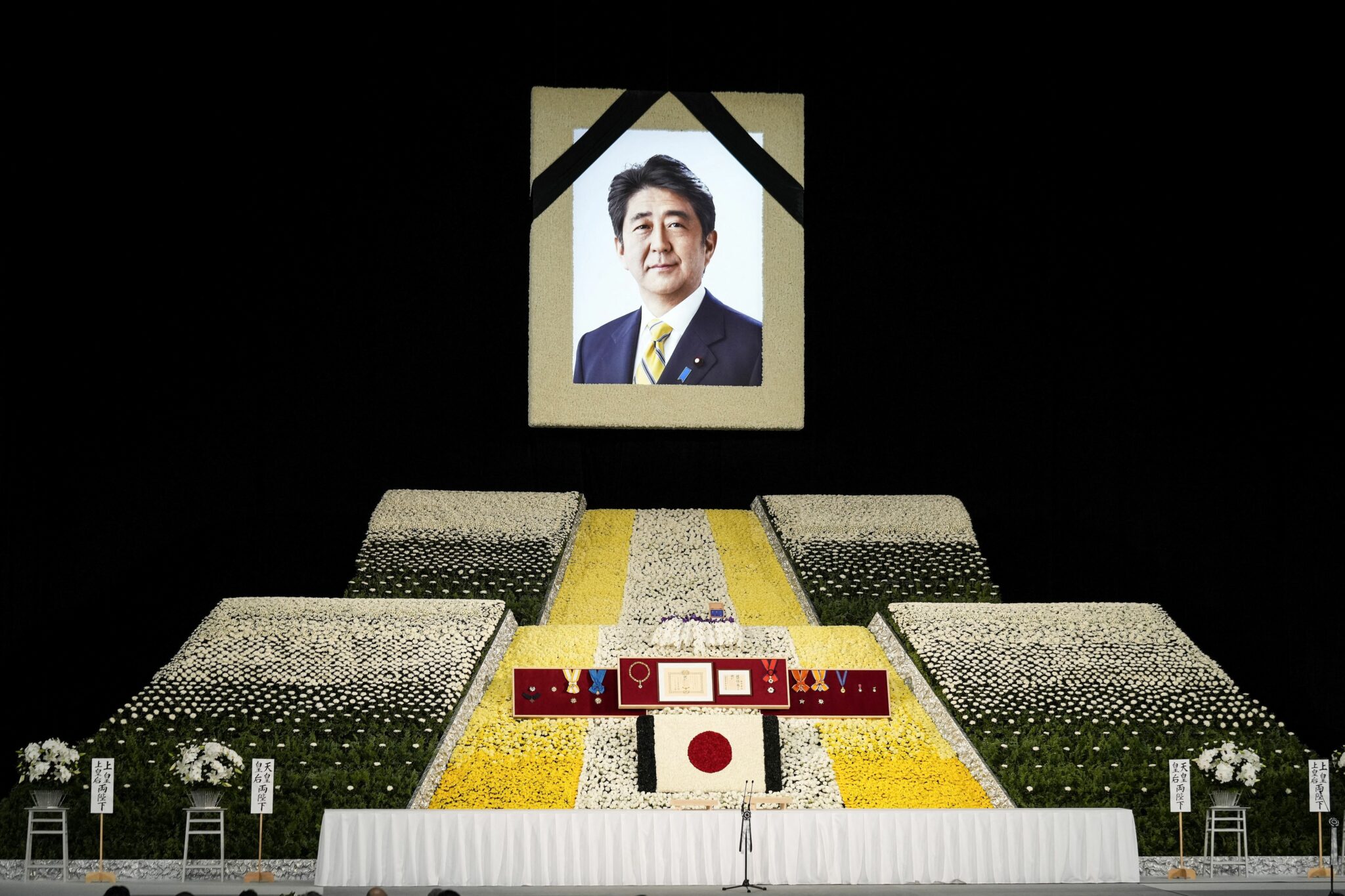 A photograph of Japan's former prime minister Shinzo Abe is displayed during his state funeral in the Nippon Budokan in Tokyo on September 27, 2022. (Photo by FRANCK ROBICHON / POOL / AFP) (Photo by FRANCK ROBICHON/POOL/AFP via Getty Images)
