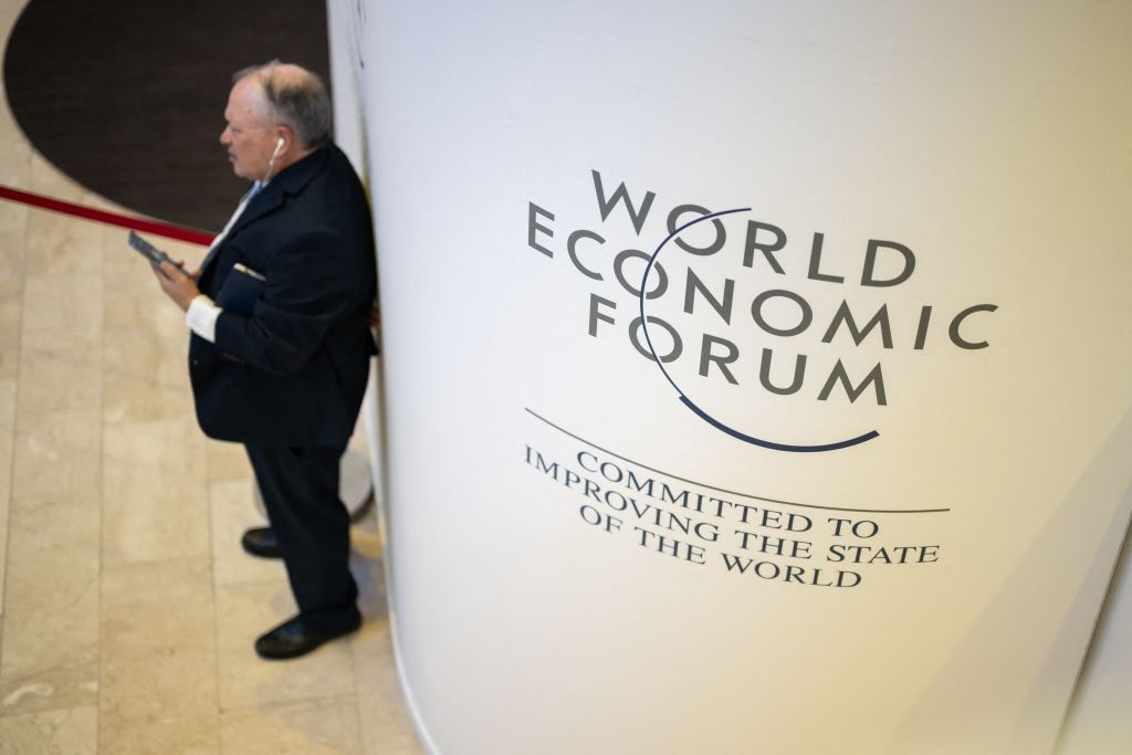 A participant uses his mobile phone at the Congress centre during the World Economic Forum (WEF) annual meeting in Davos on January 18, 2023. (Photo by Fabrice COFFRINI / AFP) (Photo by FABRICE COFFRINI/AFP via Getty Images)