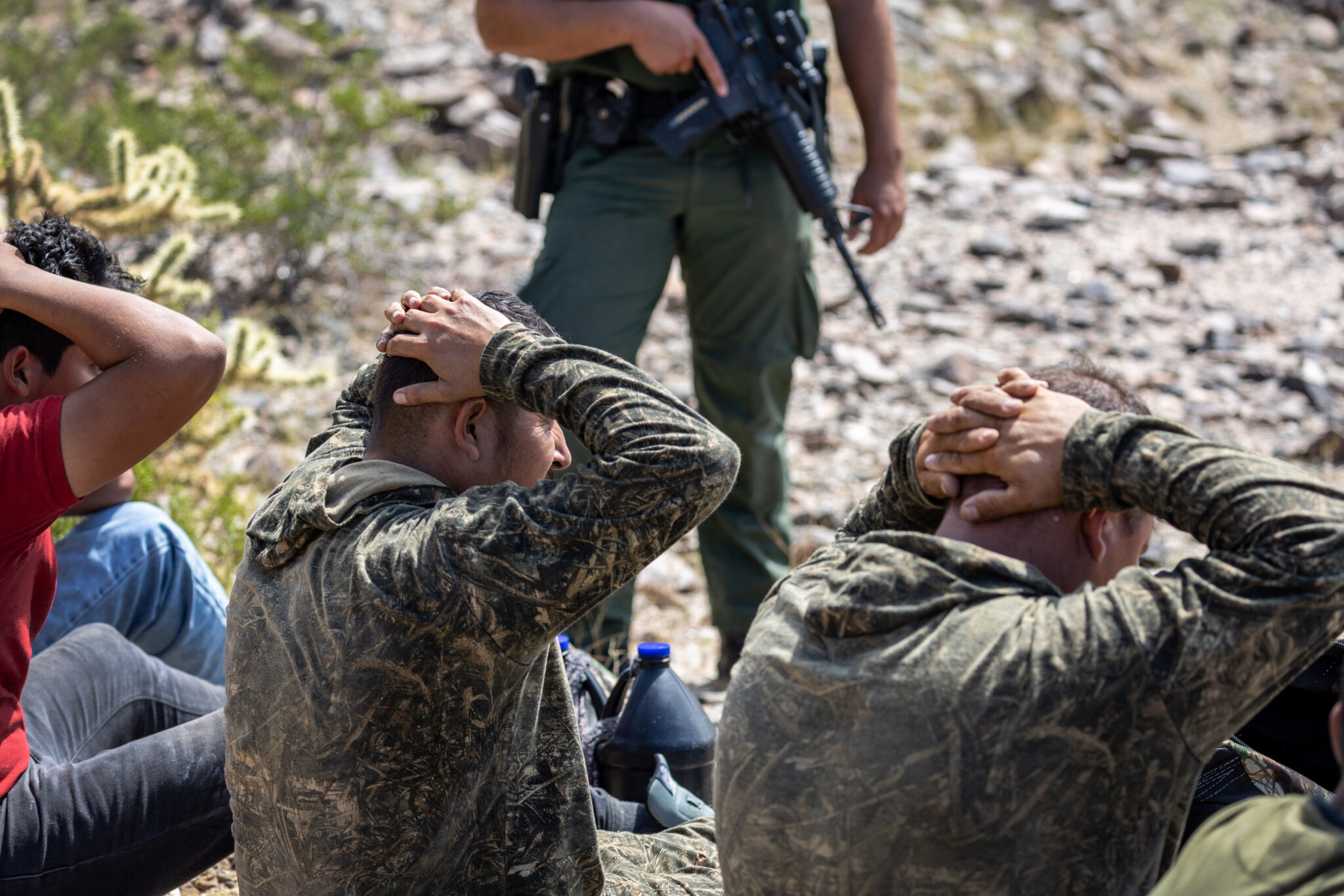 ORGAN PIPE NATIONAL MONUMENT, ARIZONA - SEPTEMBER 28: A U.S. Border Patrol agents guards a group of immigrants after tracking them through rugged terrain on September 28, 2022 at the Organ Pipe National Monument, Arizona. U.S. immigration authorities made more than 2 million arrests along the U.S. southern border during the 2022 fiscal year, which ends September 30, the first time to reach that historic threshold. (Photo by John Moore/Getty Images)