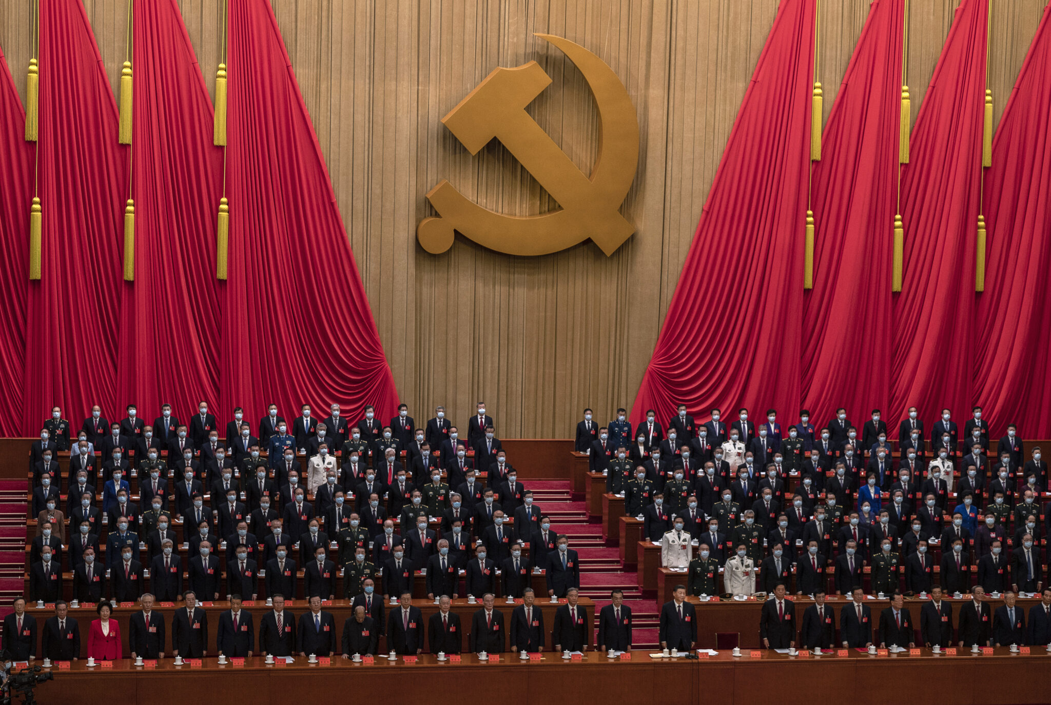 BEIJING, CHINA - OCTOBER 22: Chinese President Xi Jinping, bottom centre, and senior members of the government stand for the national anthem at the end of the closing session of the 20th National Congress of the Communist Party of China, at The Great Hall of People on October 22, 2022 in Beijing, China. China's Communist Party Congress is concluding today with incumbent President Xi Jinping expected to seal a third term in power. (Photo by Kevin Frayer/Getty Images)