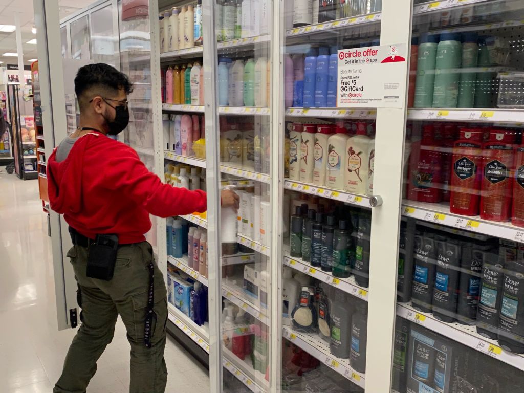 Target employee stocking personal hygiene items in new locked security shelving, Target, Queens, New York. (Photo by: Lindsey Nicholson/UCG/Universal Images Group via Getty Images)