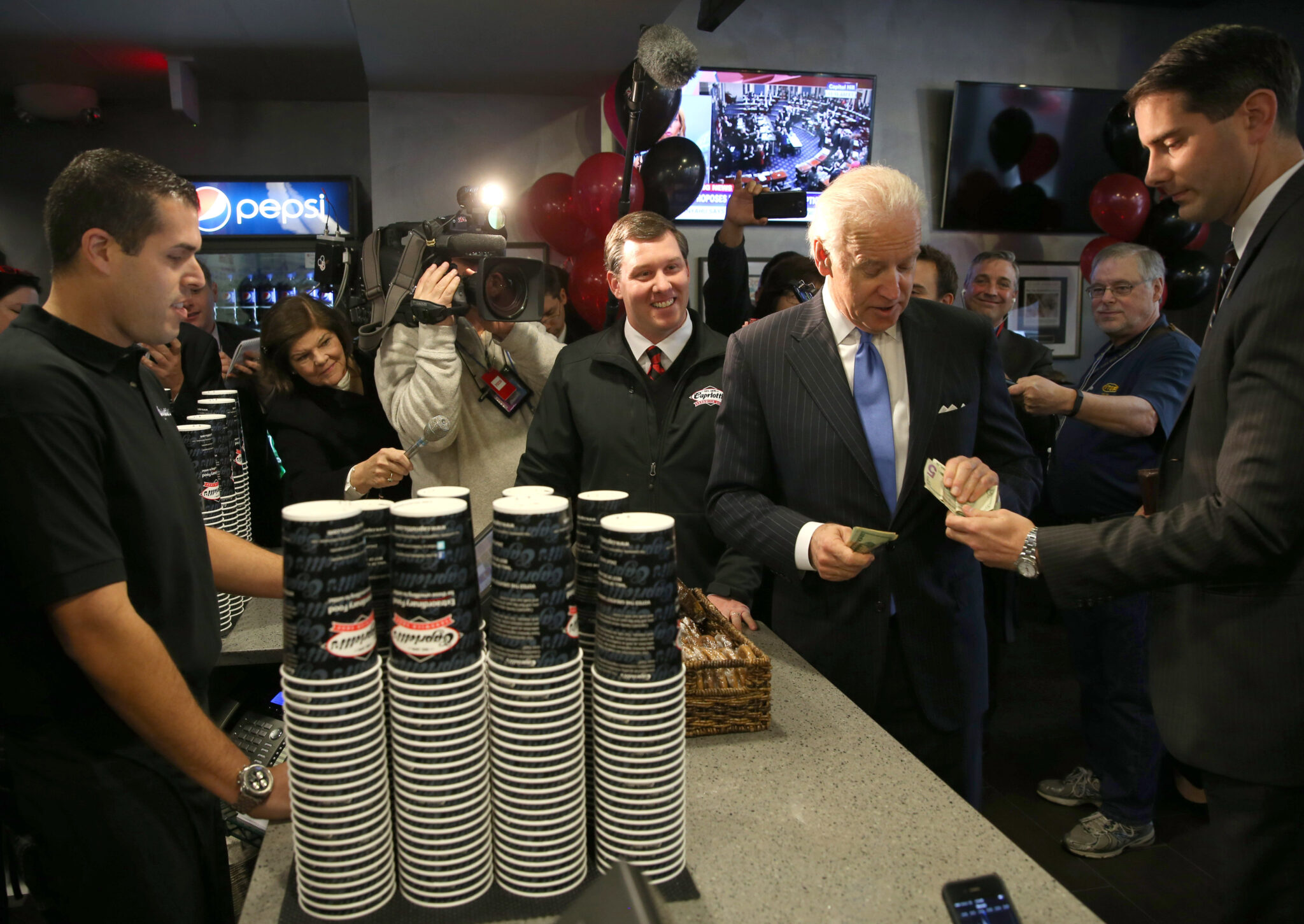 WASHINGTON, DC - NOVEMBER 21:  Vice President Joe Biden gets money to pay for his lunch at Capriotti's sandwhich shop, on November 21, 2013 in Washington, DC.  Capriotti's is a Delaware based Italian hoagie chain and a favorite of the Vice President.  (Photo by Mark Wilson/Getty Images)