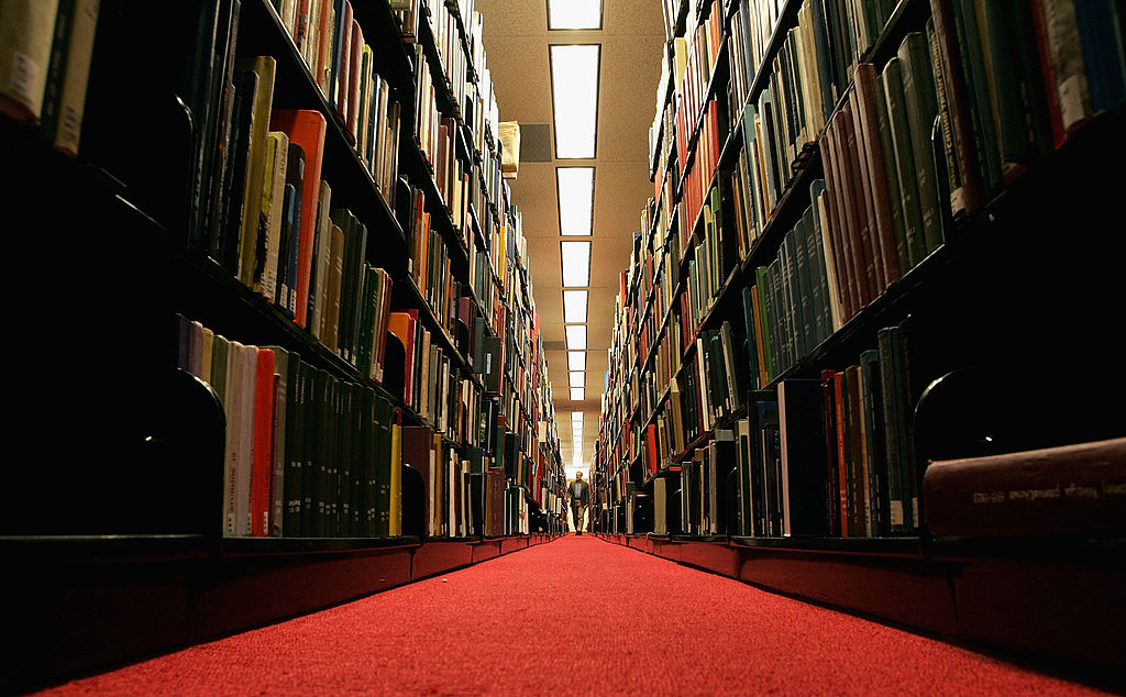 STANFORD, CA - DECEMBER 17:  A man browses through books at the Cecil H. Green on the Stanford University Campus December 17, 2004 in Stanford, California. Google, the internet search engine, has announced a long-term project to put 15 million books from seven of the world's most prestigious libraries online and make them searchable. Included will be the libraries of Harvard, Stanford, the University of Michigan, the New York Public Library and the University of Oxford, including the Bodleian. Books and periodicals will be scanned and project is expected to take six years and cost more than $100 million.  (Photo by Justin Sullivan/Getty Images)