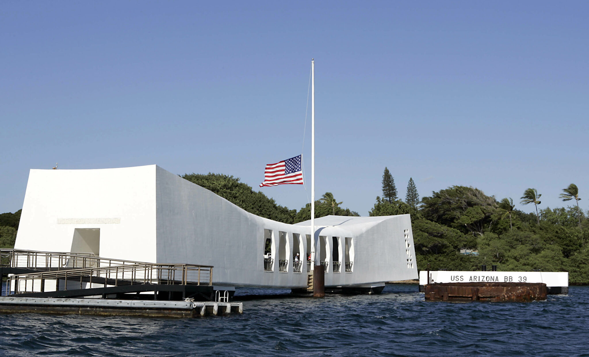 HONOLULU - DECEMBER 7:  A U.S. flag flies at half mast aboard the USS Arizona Memorial during the ceremony honoring the 64th anniversary of the surprise attack on Pearl Harbor, December 7, 2005 at Pearl Harbor, Hawaii. Around the country, Pearl Harbor survivors and others paid tribute to those lost during the December 7, 1941 Japanese bombing of Pearl Harbor.  (Photo by Marco Garcia/Getty Images)