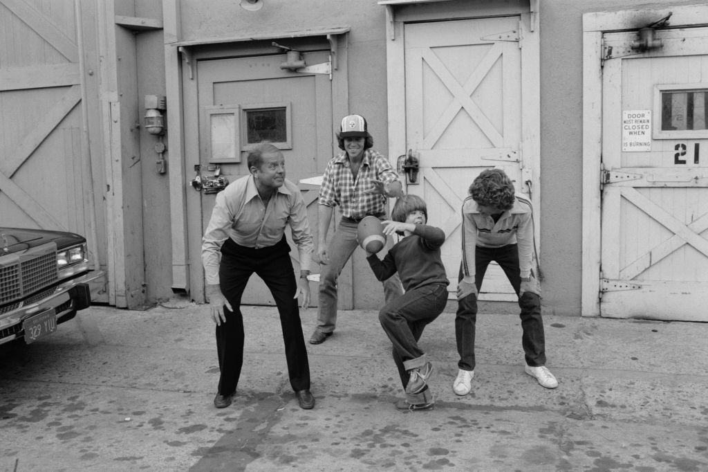 Dick Van Patten, Adam Rich, Willie Aames and Grant Goodeve, actors of television series Eight is Enough, playing football. (Photo by Tony Korody/Sygma/Sygma via Getty Images)