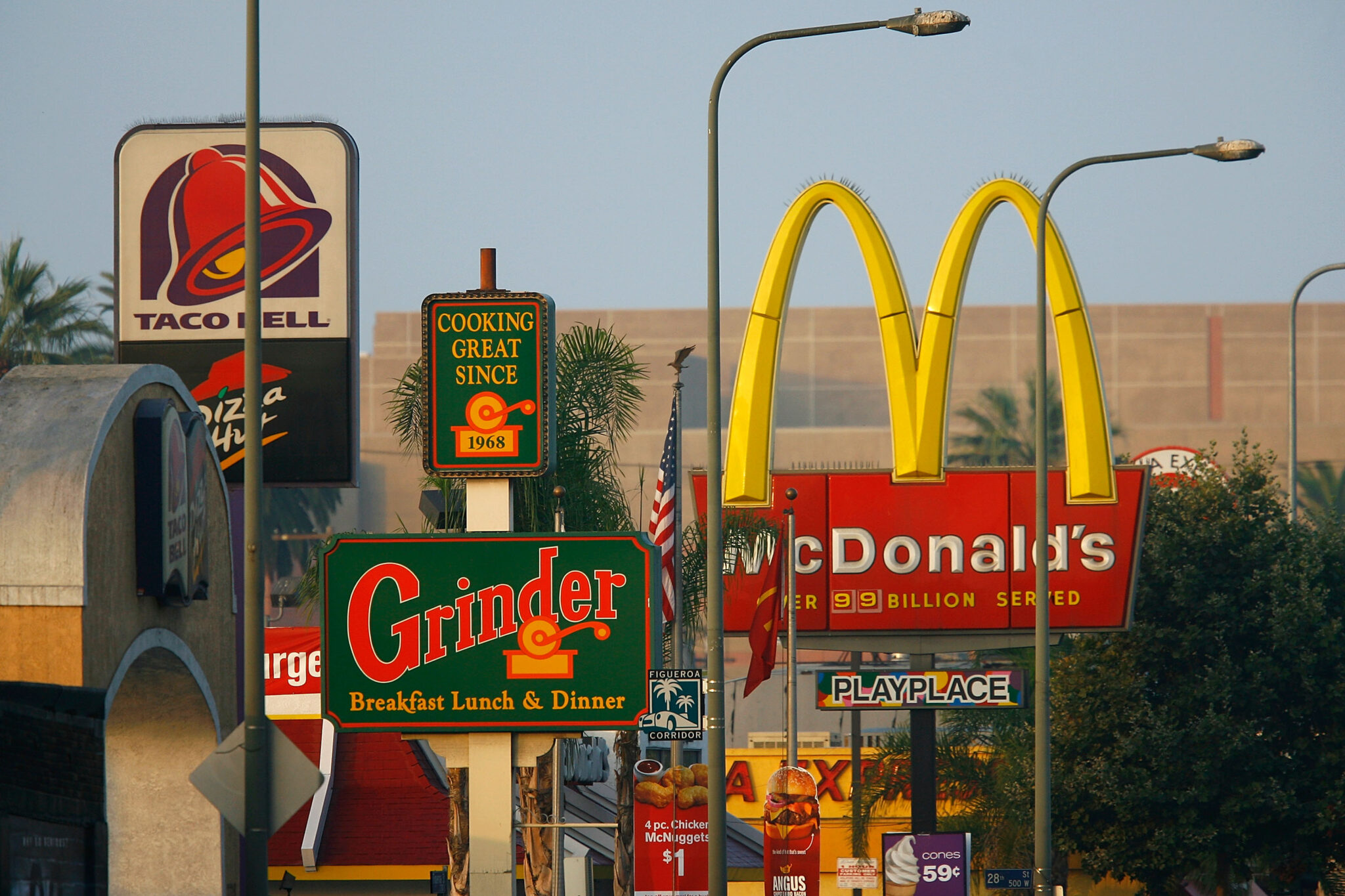 LOS ANGELES, CA - JULY 24:  Signs for Taco Bell, Grinder, McDonalds, Panda Express fast-food restaurant line the streets in the Figueroa Corridor area of South Los Angeles on July 24, 2008, Los Angeles, California. The Los Angeles City Council committee has unanimously approved year-long moratorium on new fast-food restaurants in a 32-square-mile area, mostly in South Los Angeles, pending approval by the full council and the signature of Mayor Antonio Villaraigosa to make it the law. South LA has the highest concentration of fast-food restaurants of the city, about 400, and only a few grocery stores. L.A. Councilwoman Jan Perry proposed the measure to try to reduce health problems associated with a diet high in fast-food, like obesity and diabetes, which plague many of the half-million people living there.  (Photo by David McNew/Getty Images)