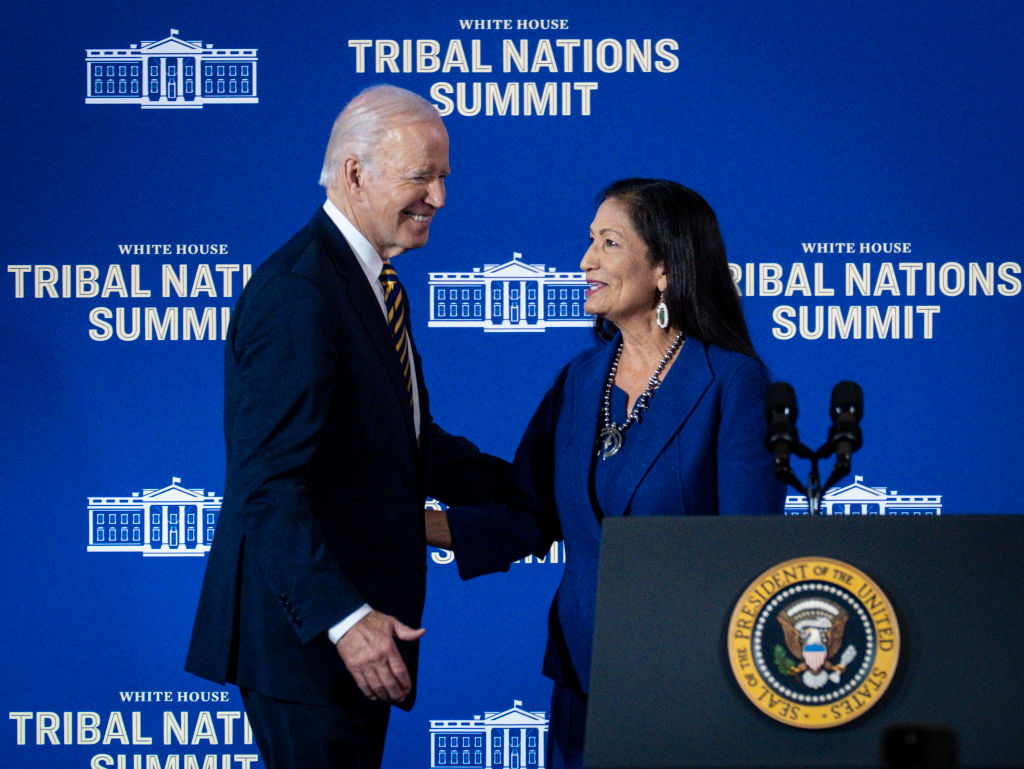 WASHINGTON, DC - November 30:  US President Joe Biden greets Department of the Interior Secretary Deb Haaland during the 2022 White House Tribal Nations Summit at the Department of the Interior on November 30, 2022 in Washington, DC. The Summit will feature new Administration announcements and efforts to implement key policy initiatives supporting Tribal communities.  (Photo by Pete Marovich/Getty Images)