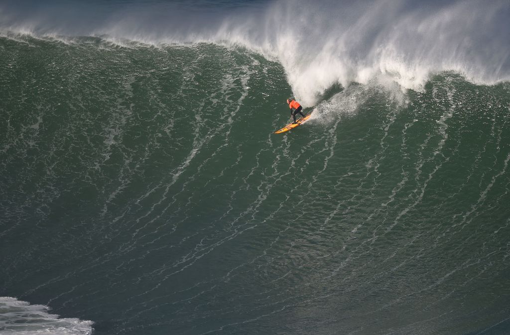 TOPSHOT - A surfer competes during the Punta Galea Challenge big wave surfing international competition in the Northern Spanish city of Getxo on February 22, 2022. - Punta Galea Challenge is the oldest big wave surfing competition in Europe. (Photo by ANDER GILLENEA / AFP) (Photo by ANDER GILLENEA/AFP via Getty Images)