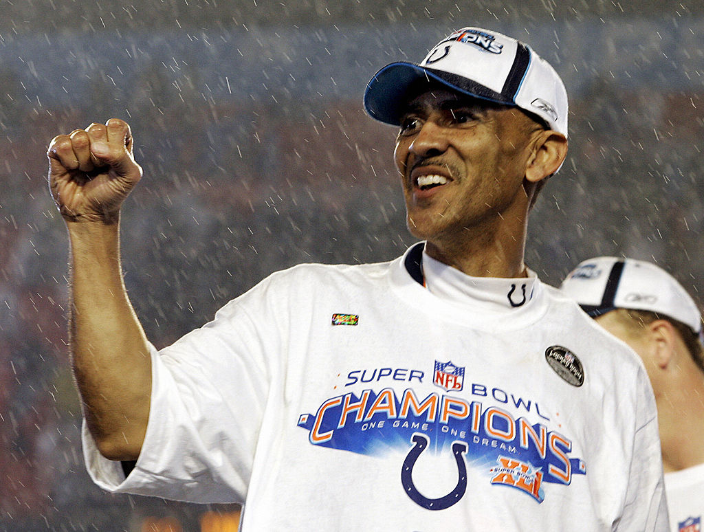 Miami, UNITED STATES: With the rain pouring down, coach Tony Dungy of the Indianapolis Colts celebrates his team's 29-17 victory over the Chicago Bears in Super Bowl XLI on 04 February 2007 at Dolphin Stadium in Miami, Florida.  Dungy become the first black coach to hold the Vince Lombardi Trophy, which is given to the Super Bowl champ. (Photo credit should read JEFF HAYNES/AFP via Getty Images)